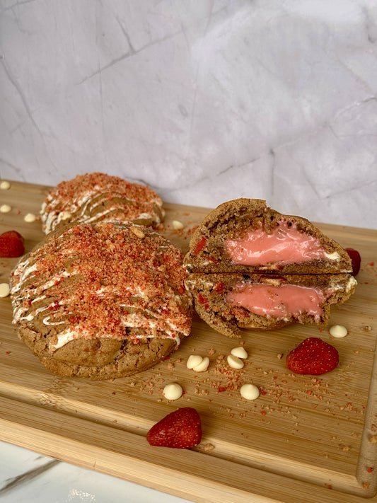 Shortcake Shawty - Strawberry Shortcake Cookie with pink praline filling, white chocolate drizzle, and strawberry crunch topping by Sinful Bites Las Vegas